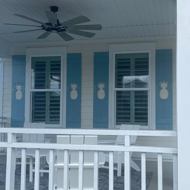 Blue Shutters with a pineapple cut out on a house